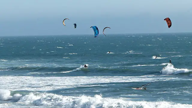 Surfers kitesurfing in Gizzeria Lido.