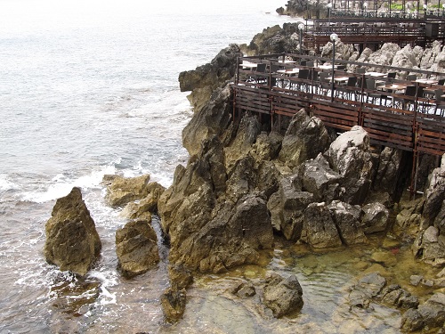 restaurants surrounded by rocks and sea