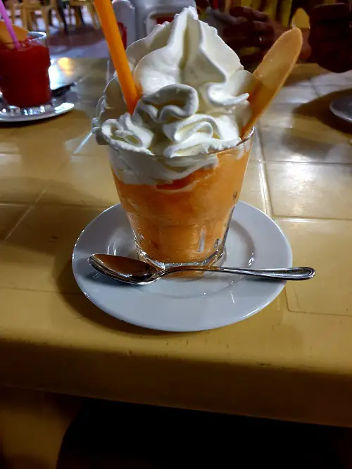 A crushed ice drink with fresh fruit and whipped cream is typical bar culture behaviour