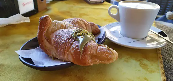 A pistachio cream croissant with cappuccino is part of the bar culture in Calabria