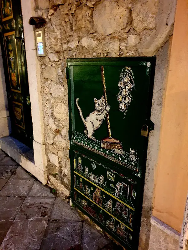 A street with art decorative panels showing a cat