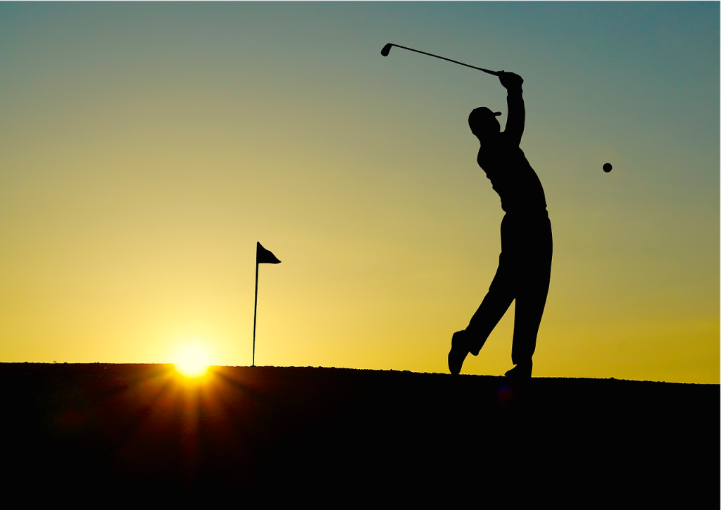 Playing golf at sunset